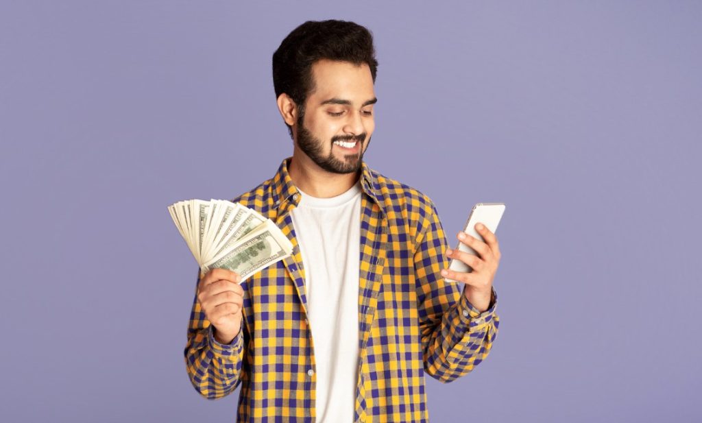 man with cash and phone
